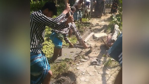 স্কুল শিক্ষকের বাড়ির রাস্তা কেটে পুকুরে নিক্ষেপ